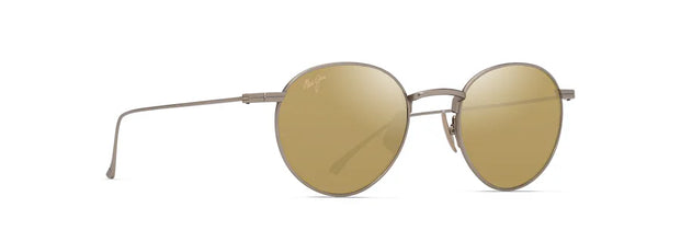 Maui Jim KA’APEHA sunglass frame in matte titanium with round polarised gold lenses, shown angled to highlight the slim titanium temples and engraved Hawaiian pattern detail. Walkins welcome to Lifestyle Optical, Sydney cbd. 